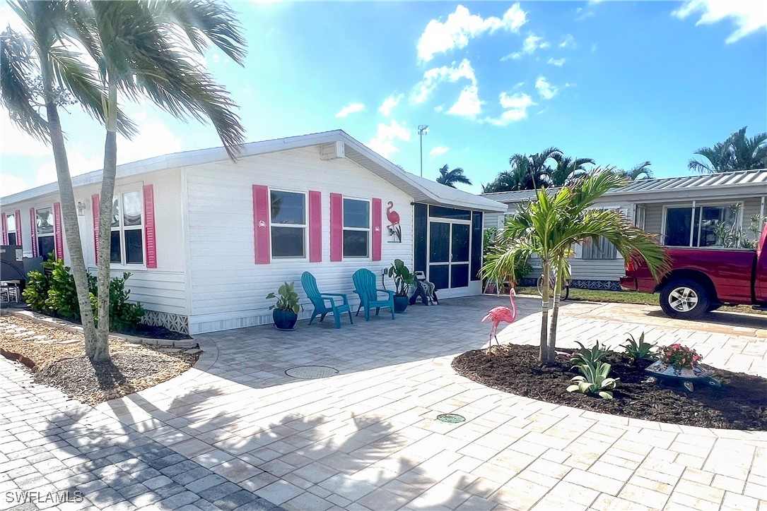 a view of a house with backyard porch and sitting area