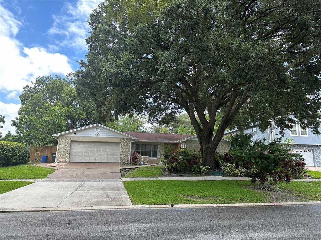 a front view of a house with a yard and a garage