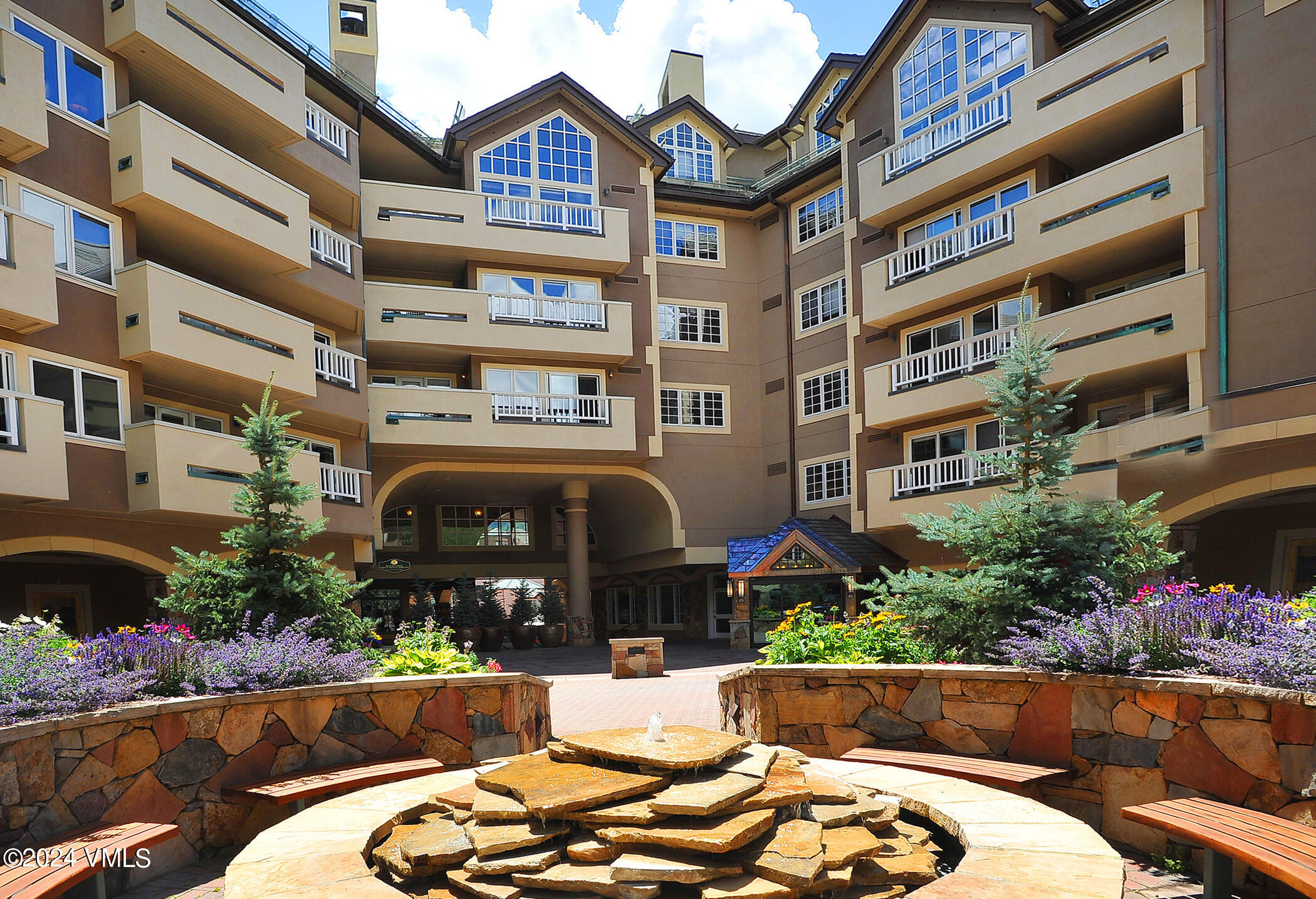 a front view of a building with plants