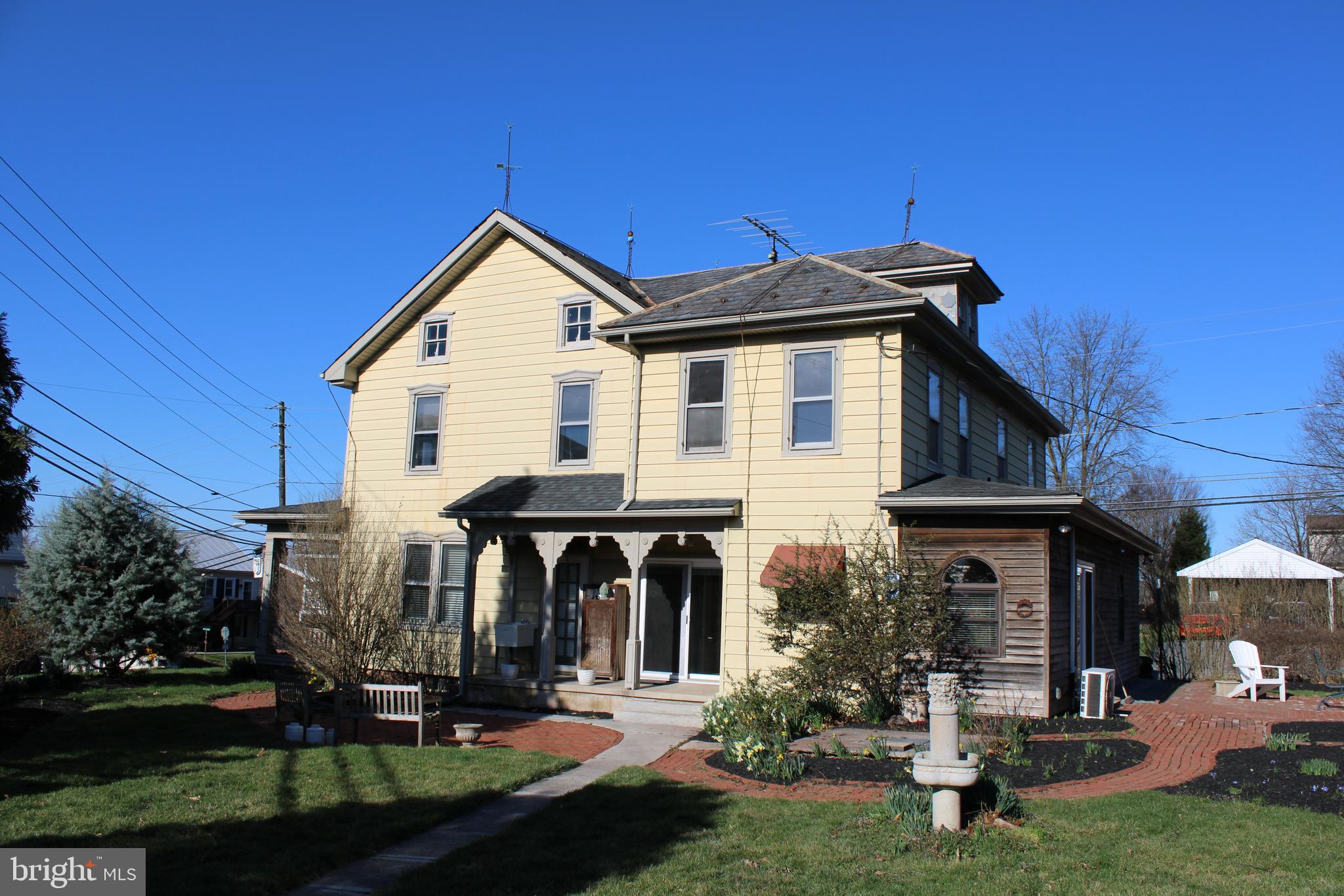 a view of a house with garden and porch