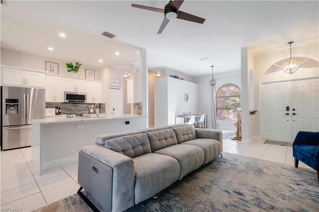 a living room with furniture and kitchen view