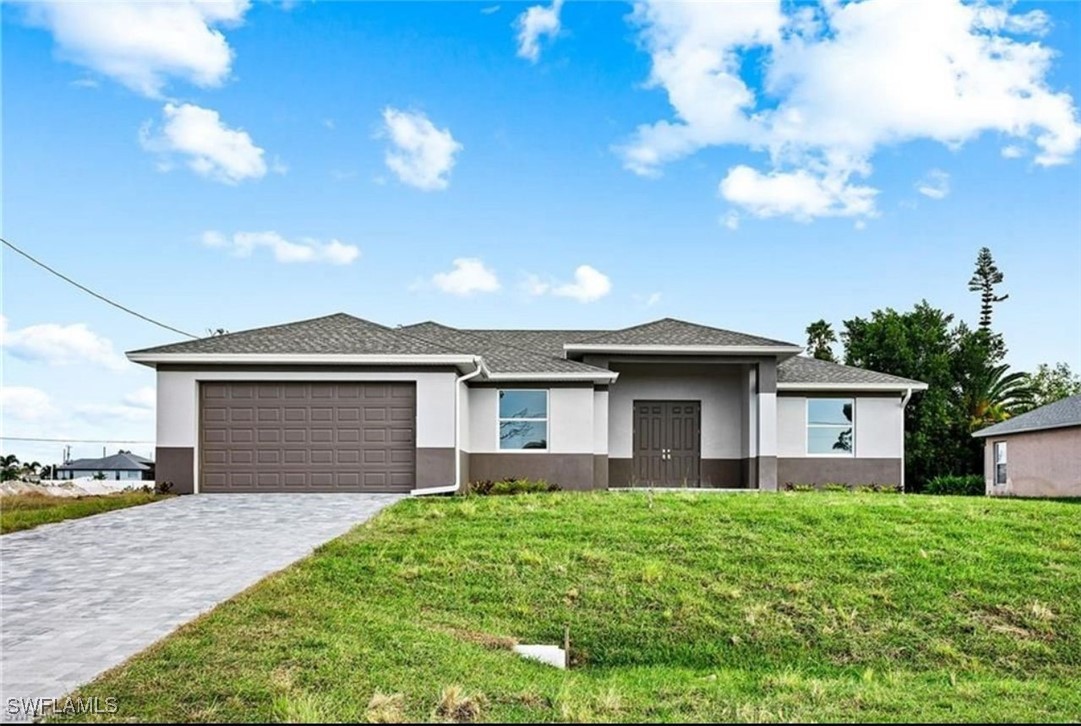 a front view of a house with a garden and yard