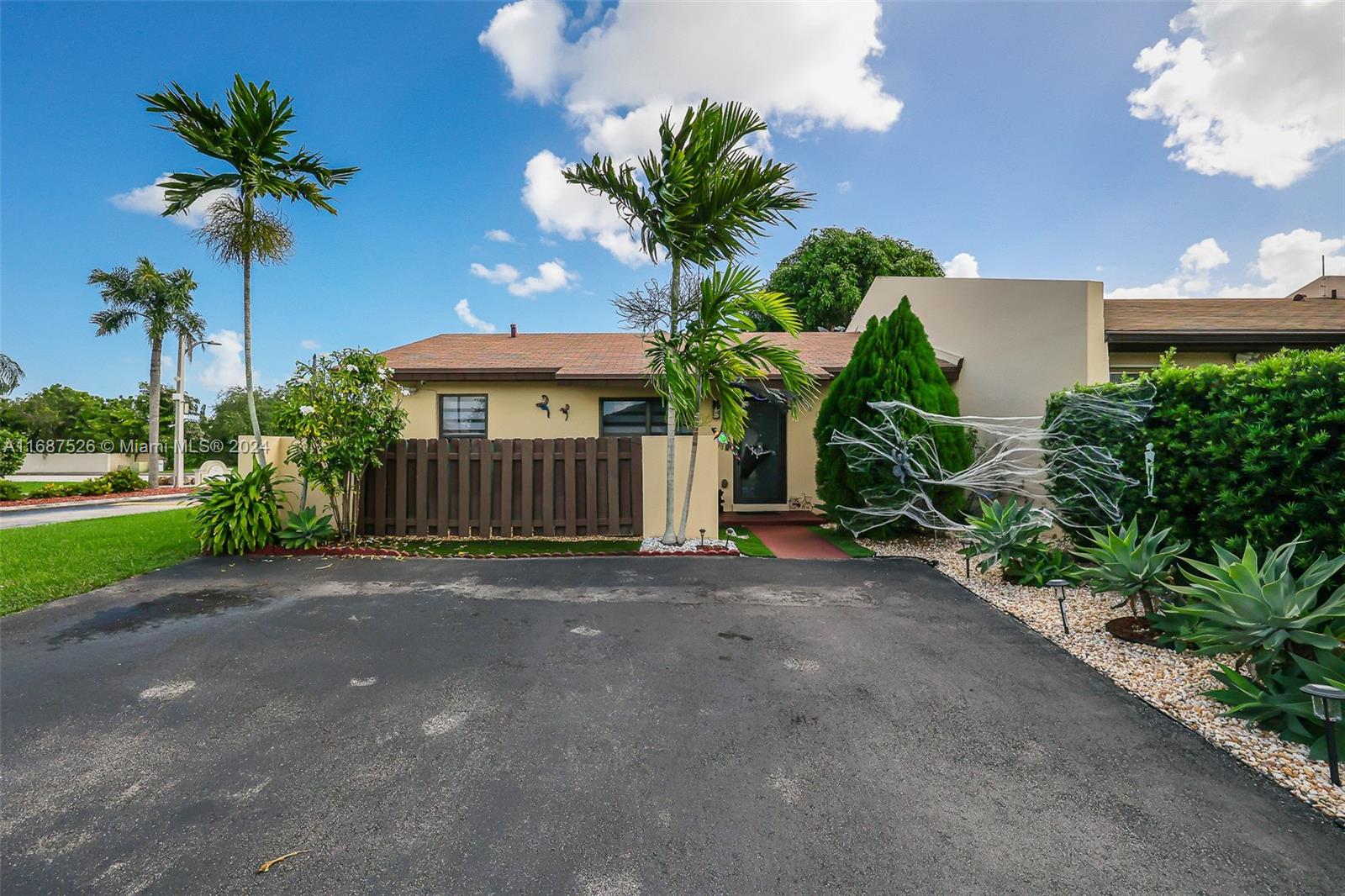 a view of a house with a yard and a palm tree