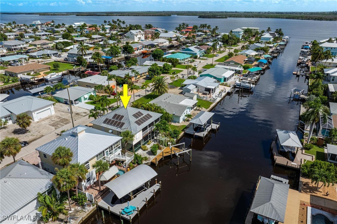 an aerial view of a house with a lake view