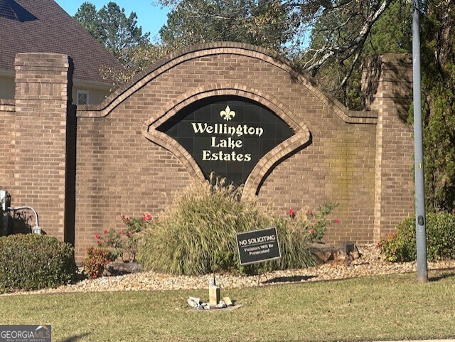 a view of sign board with buildings in the background