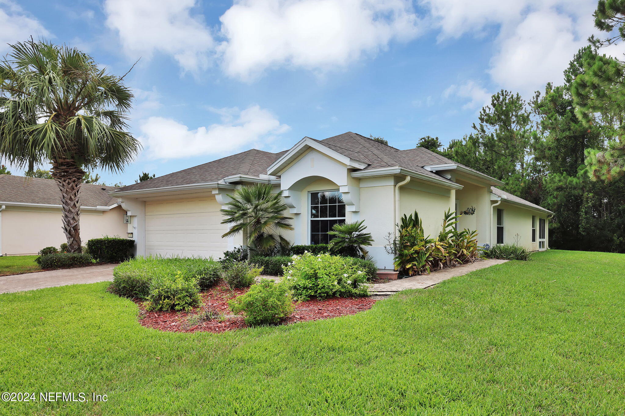 a front view of a house with a garden