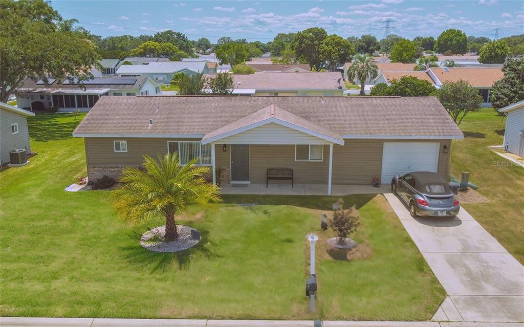 a aerial view of a house with swimming pool and a yard