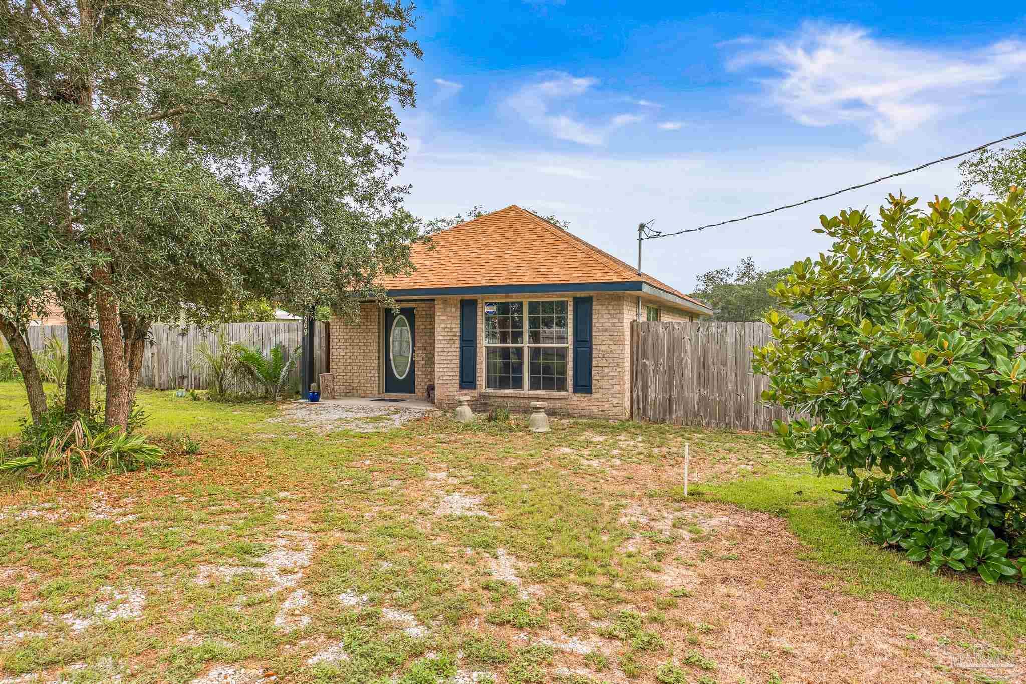 a front view of a house with a garden