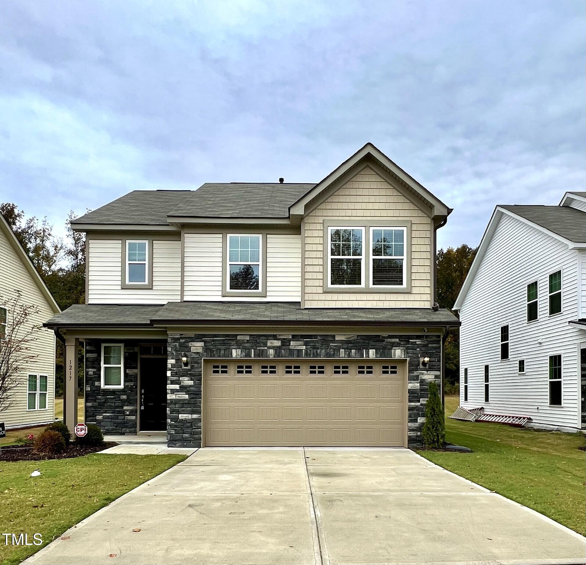 a front view of a house with yard