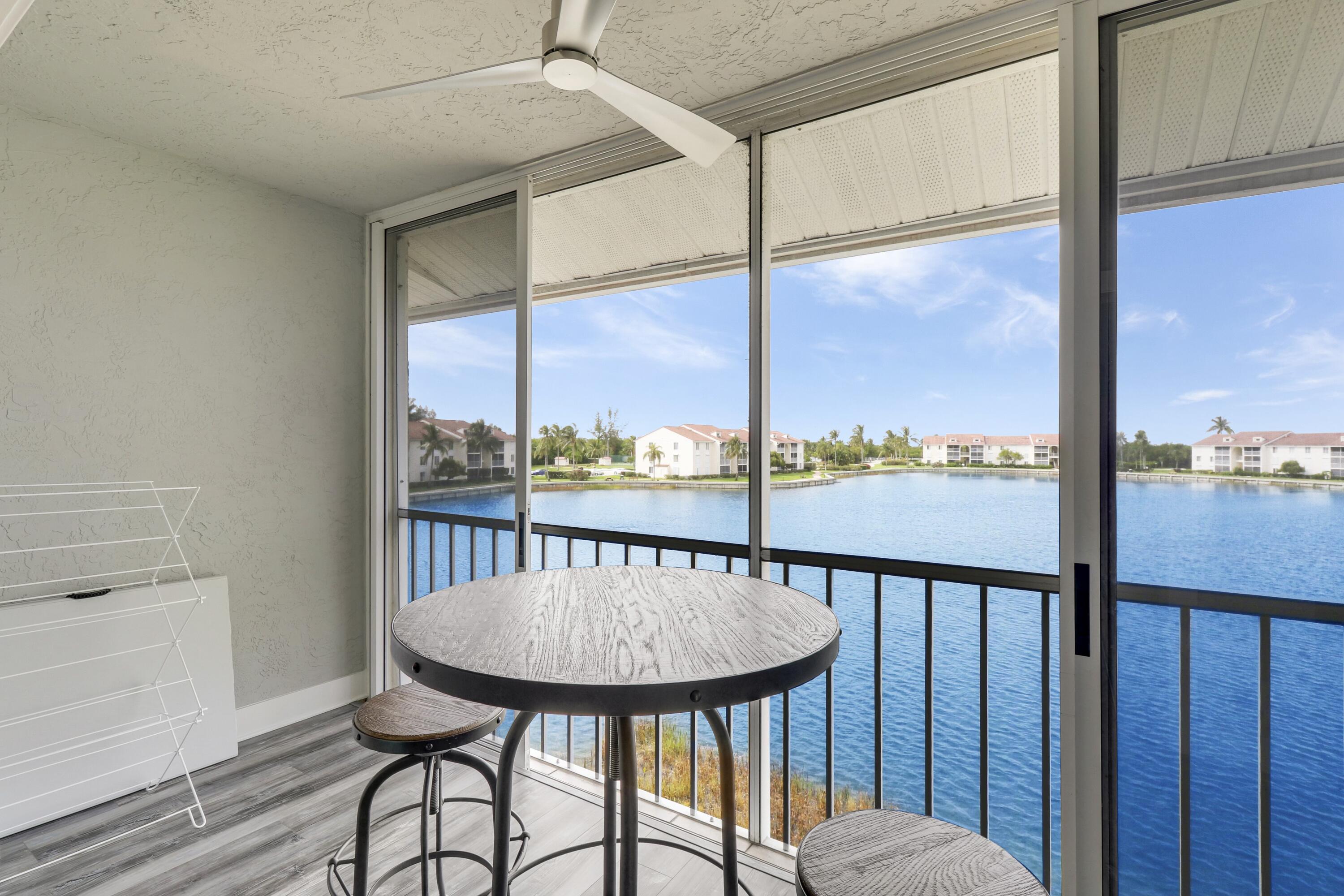 a view of a balcony with chair and wooden floor