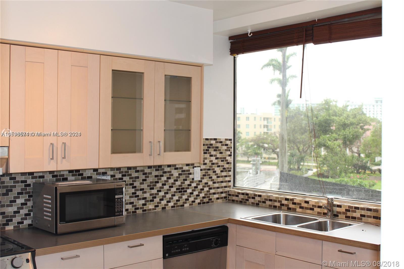 a kitchen with granite countertop a sink and a stove