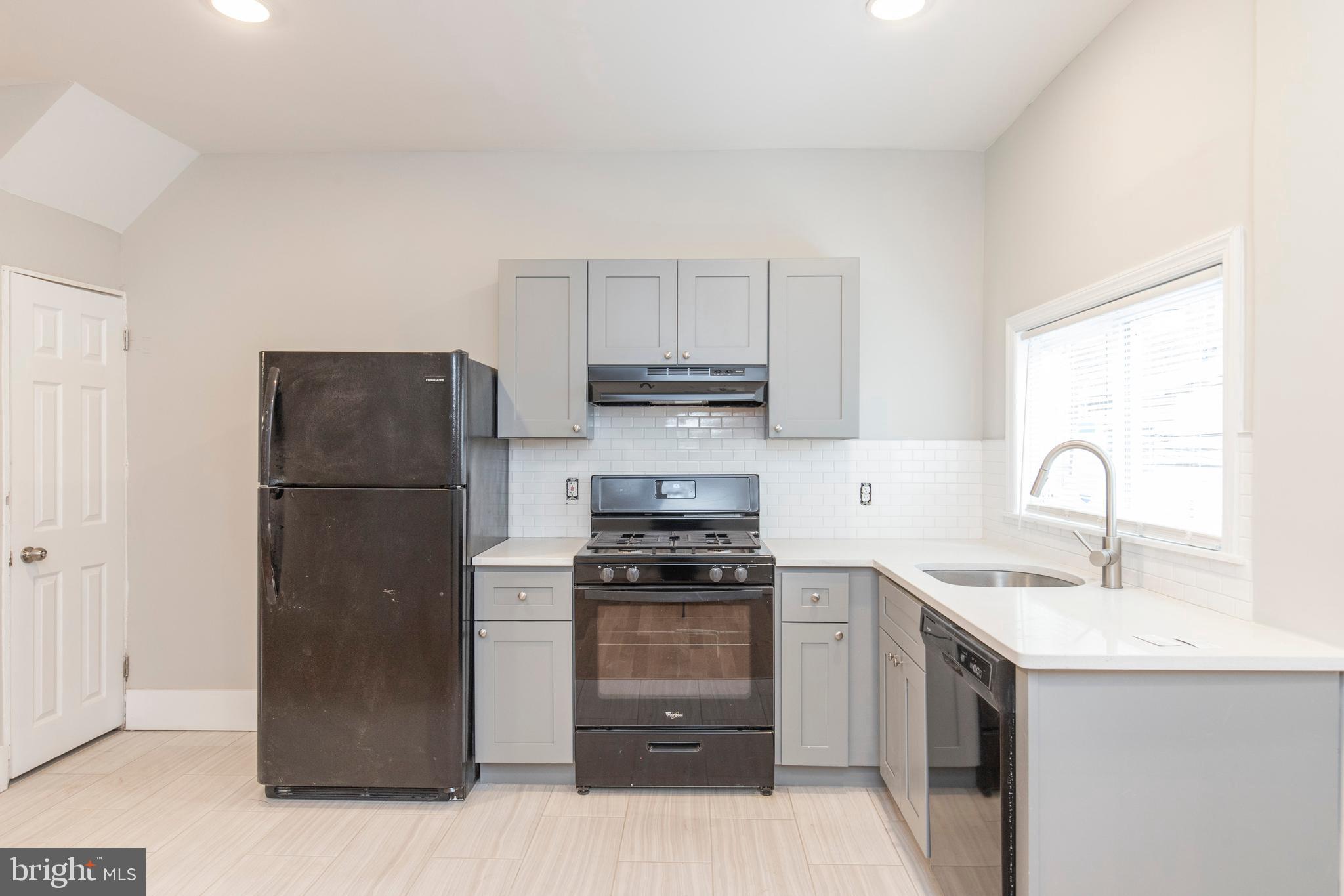 a kitchen with a sink a stove and refrigerator