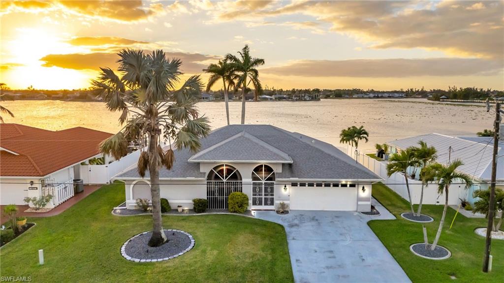 a aerial view of a house with swimming pool garden and lake view