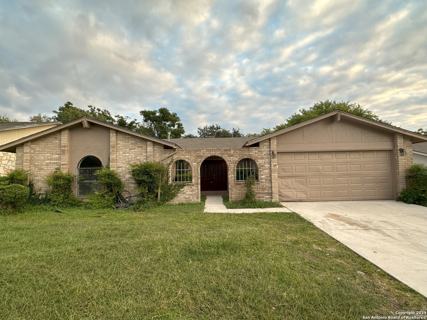 a front view of house with yard and green space