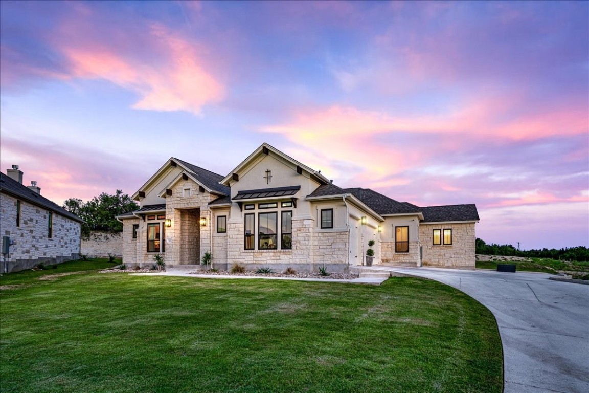 a front view of a house with a garden and deck