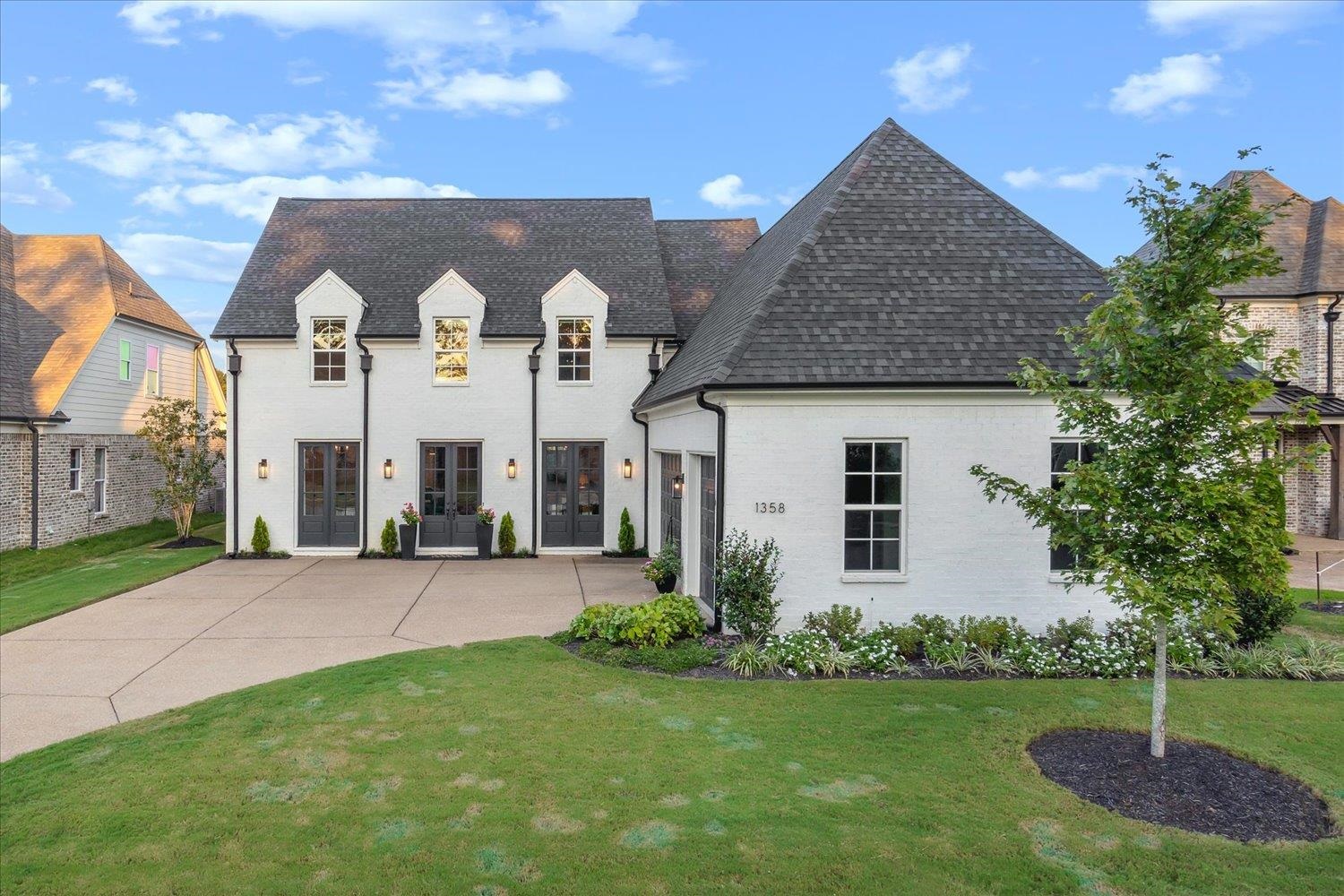 French country style house with a front yard