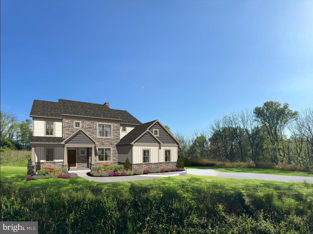 a front view of a house with a garden and trees