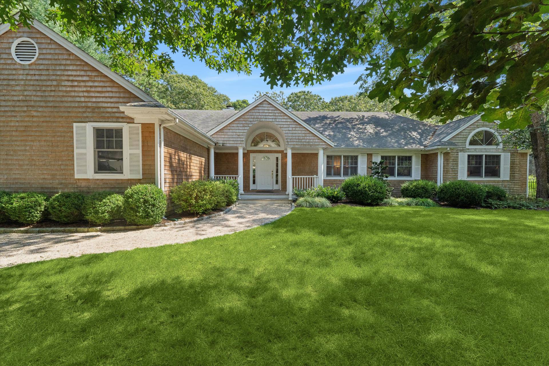 a front view of a house with a garden