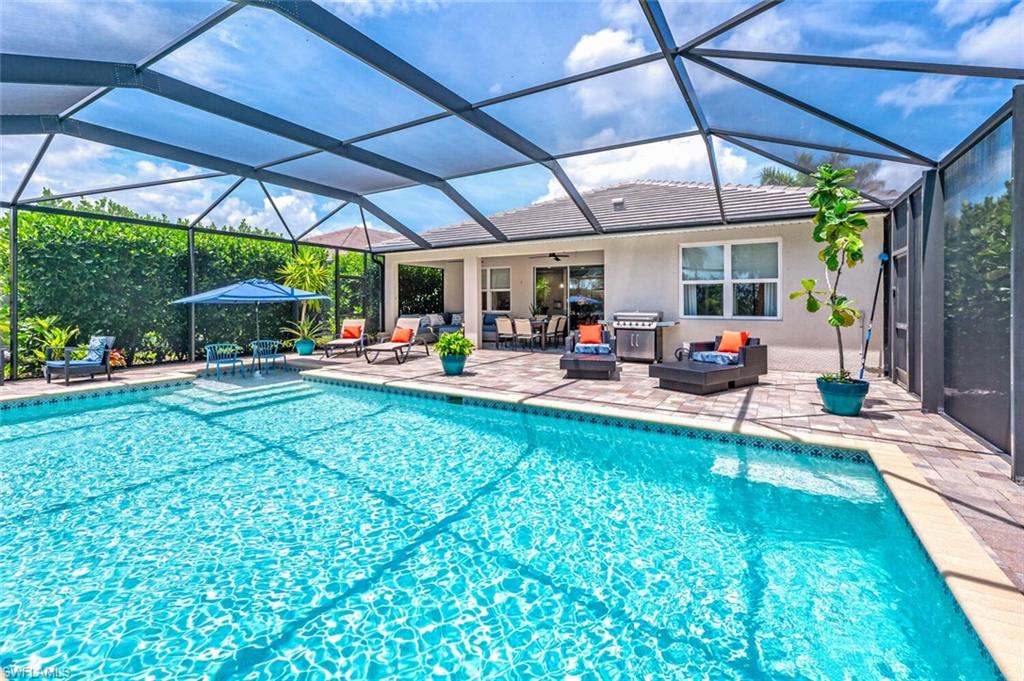 a view of a backyard with dining space and trees