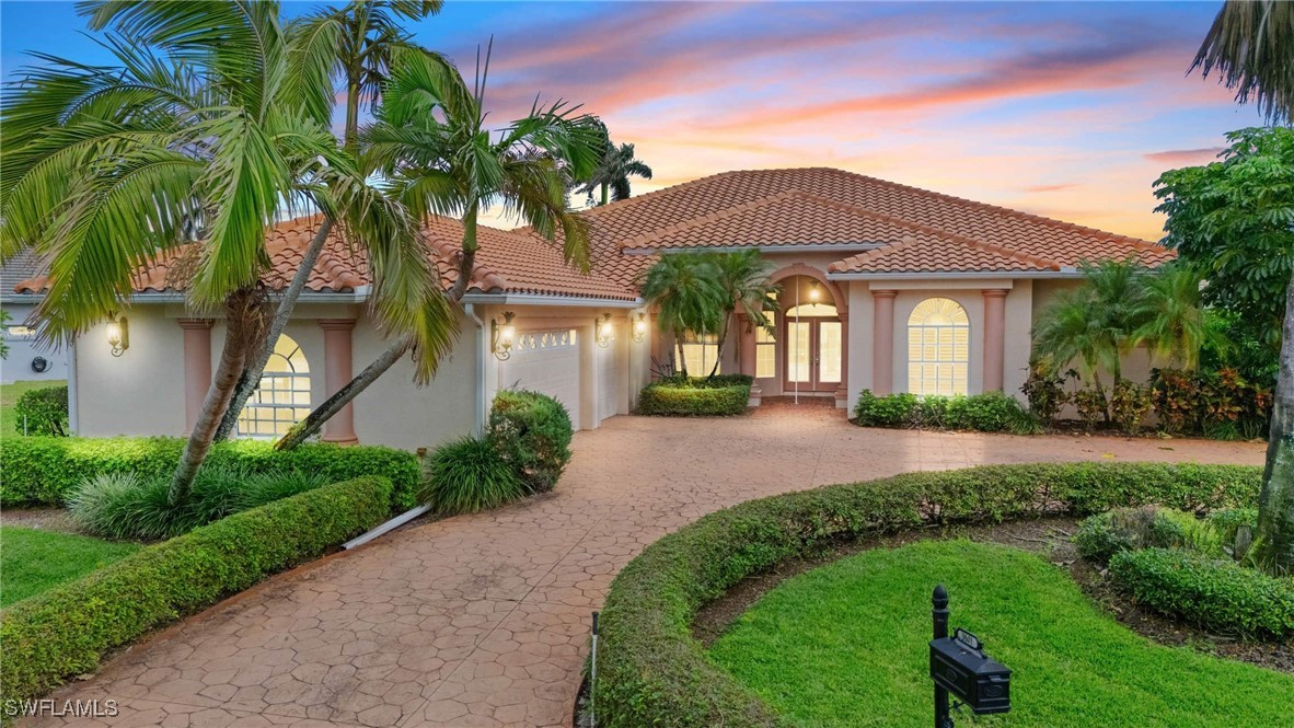 a front view of a house with a garden