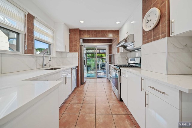 a kitchen with granite countertop a sink and a stove