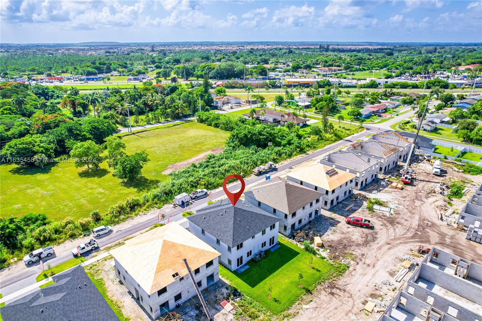 an aerial view of a house with a garden and lake view