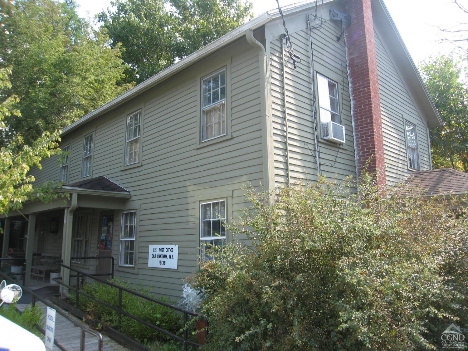 a view of a house with a yard and plants