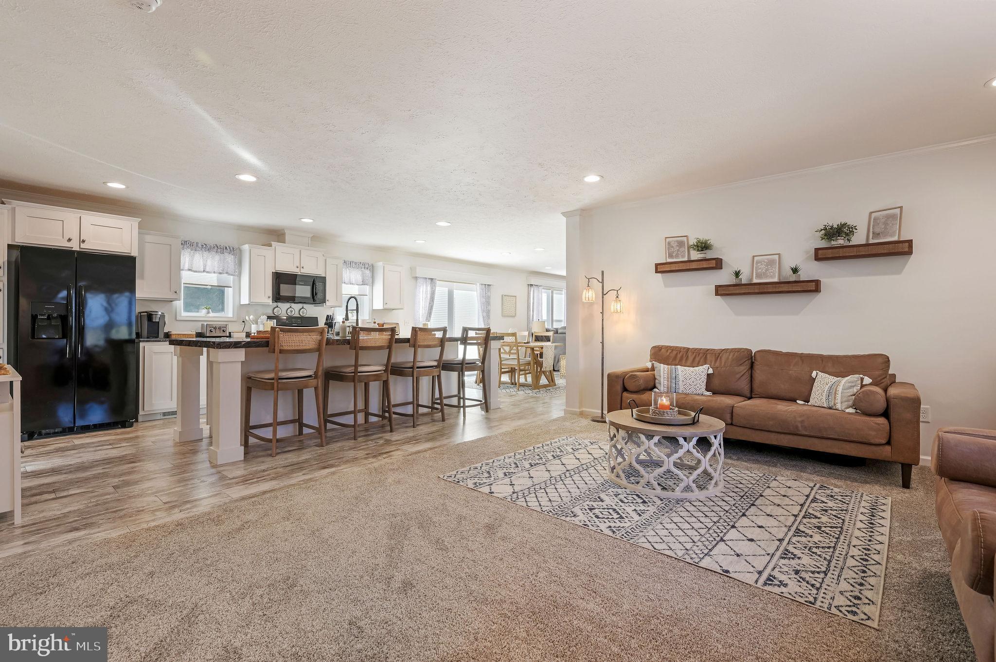 a living room with furniture and kitchen view