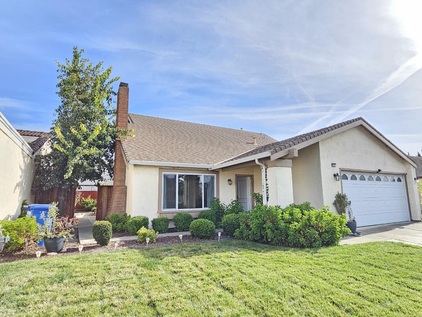 a view of an house with backyard space and garden