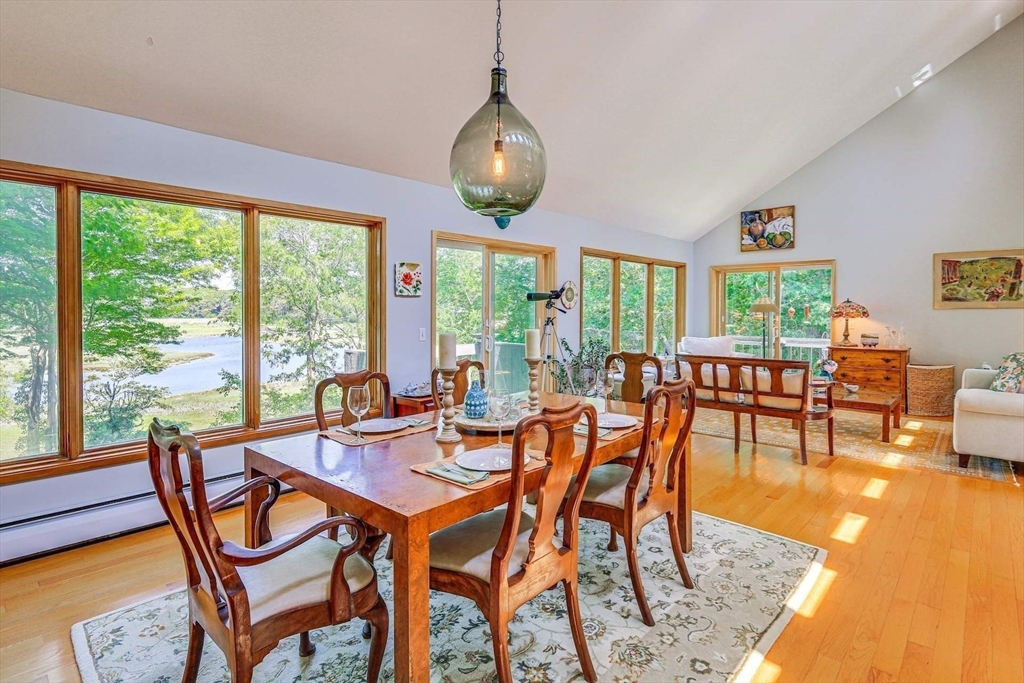 a dining room with furniture a chandelier and wooden floor