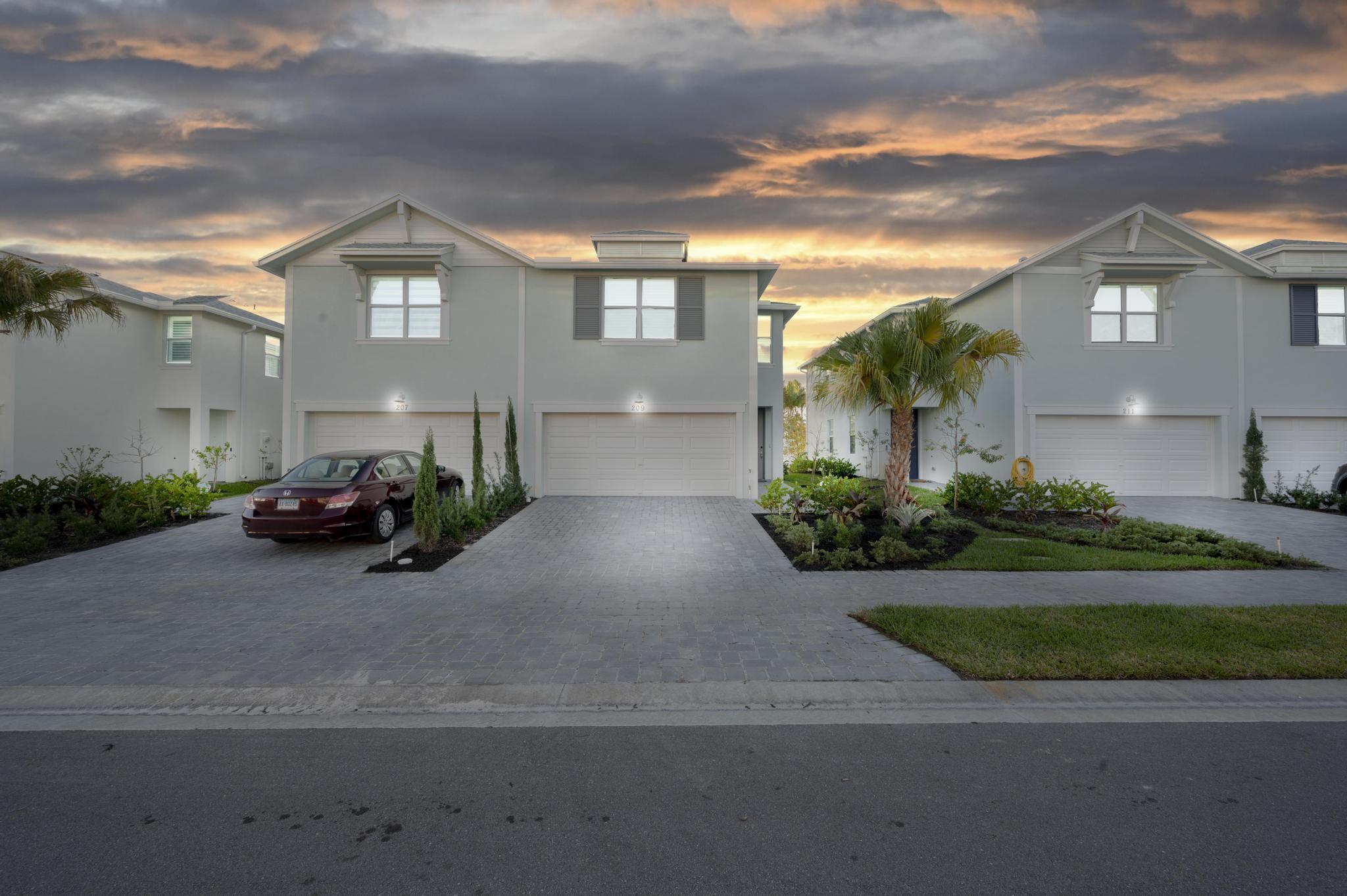 a couple of cars parked in front of a house