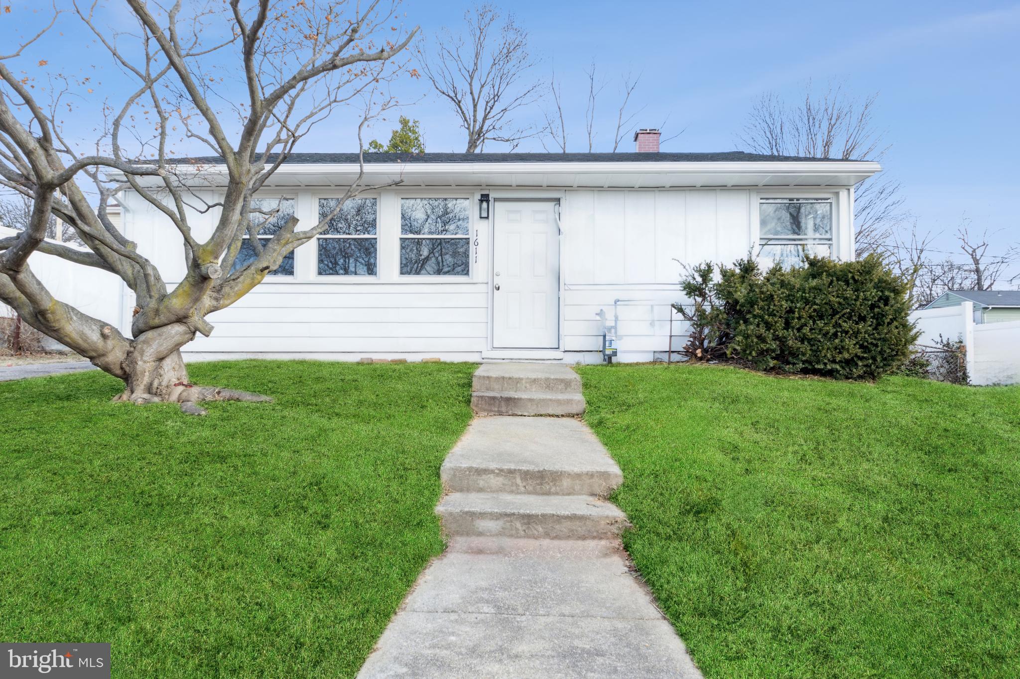 a front view of a house with a yard and an outdoor space