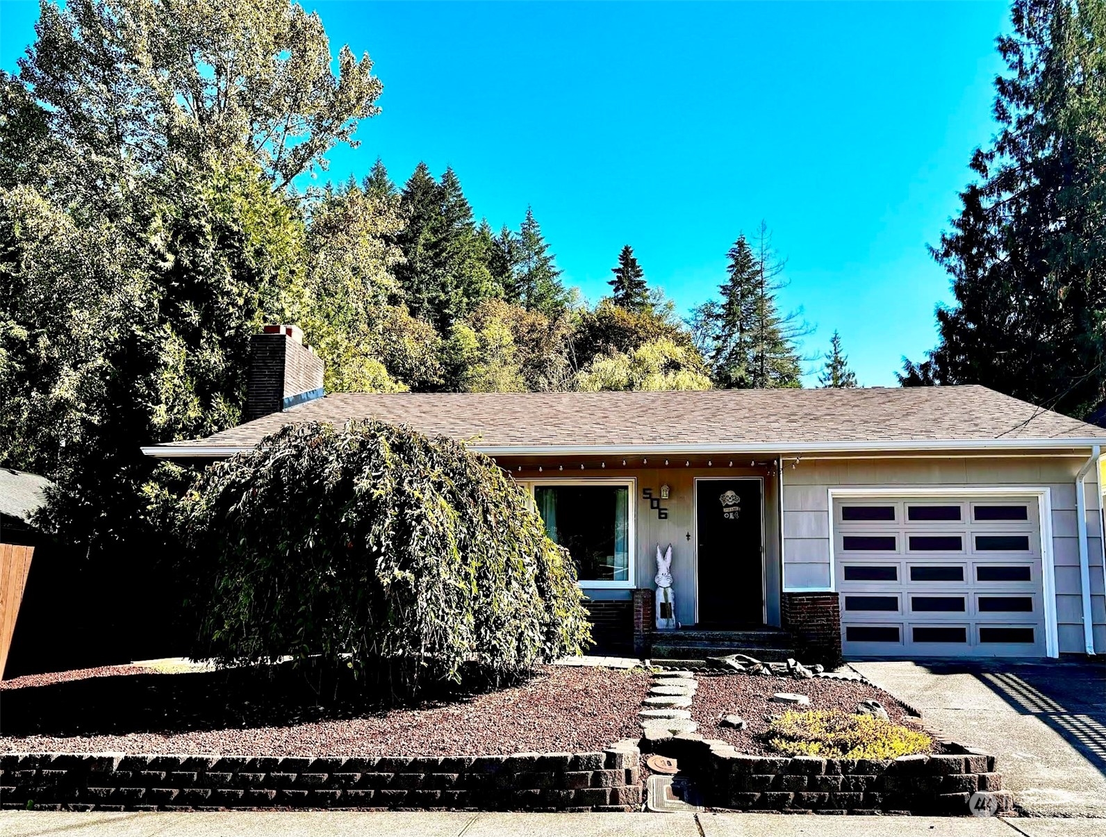 front view of a house with a garden