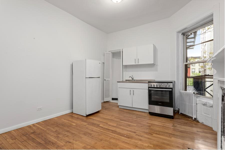 a kitchen with white cabinets and white appliances