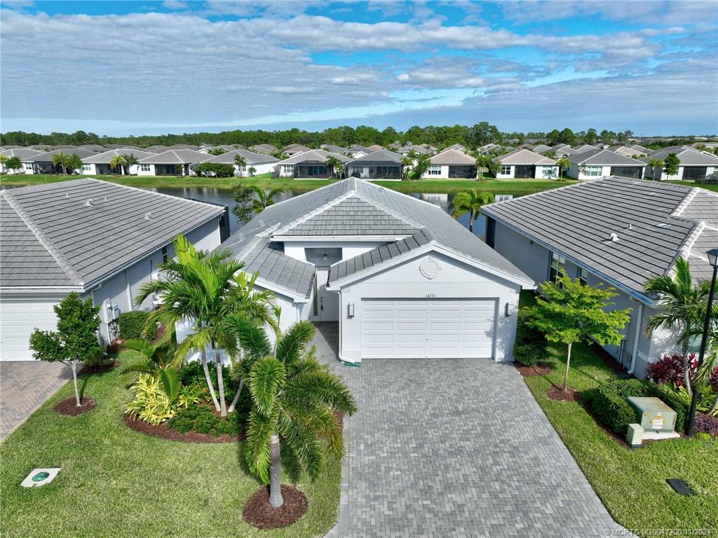 an aerial view of multiple houses with a yard