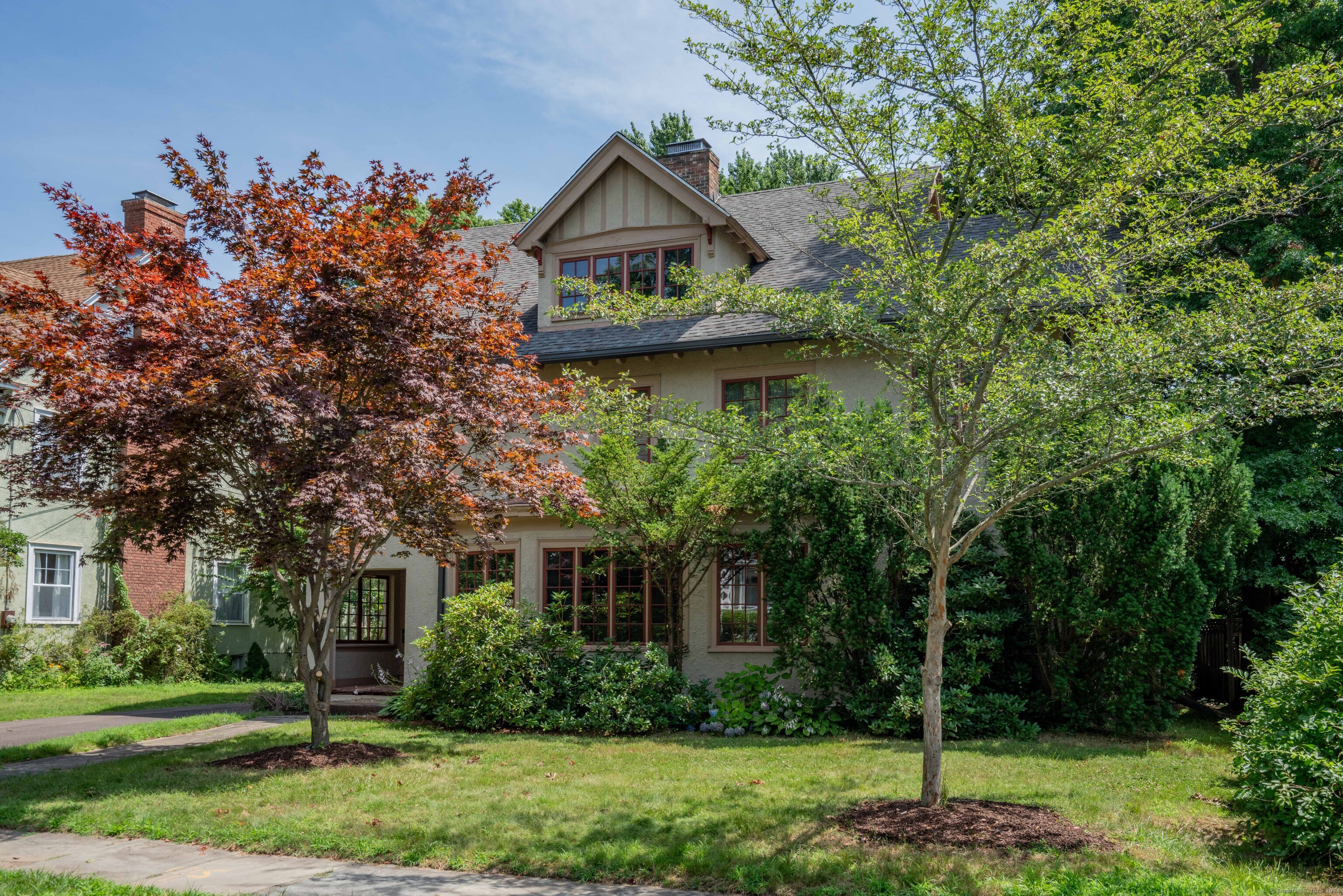 a front view of a house with a garden