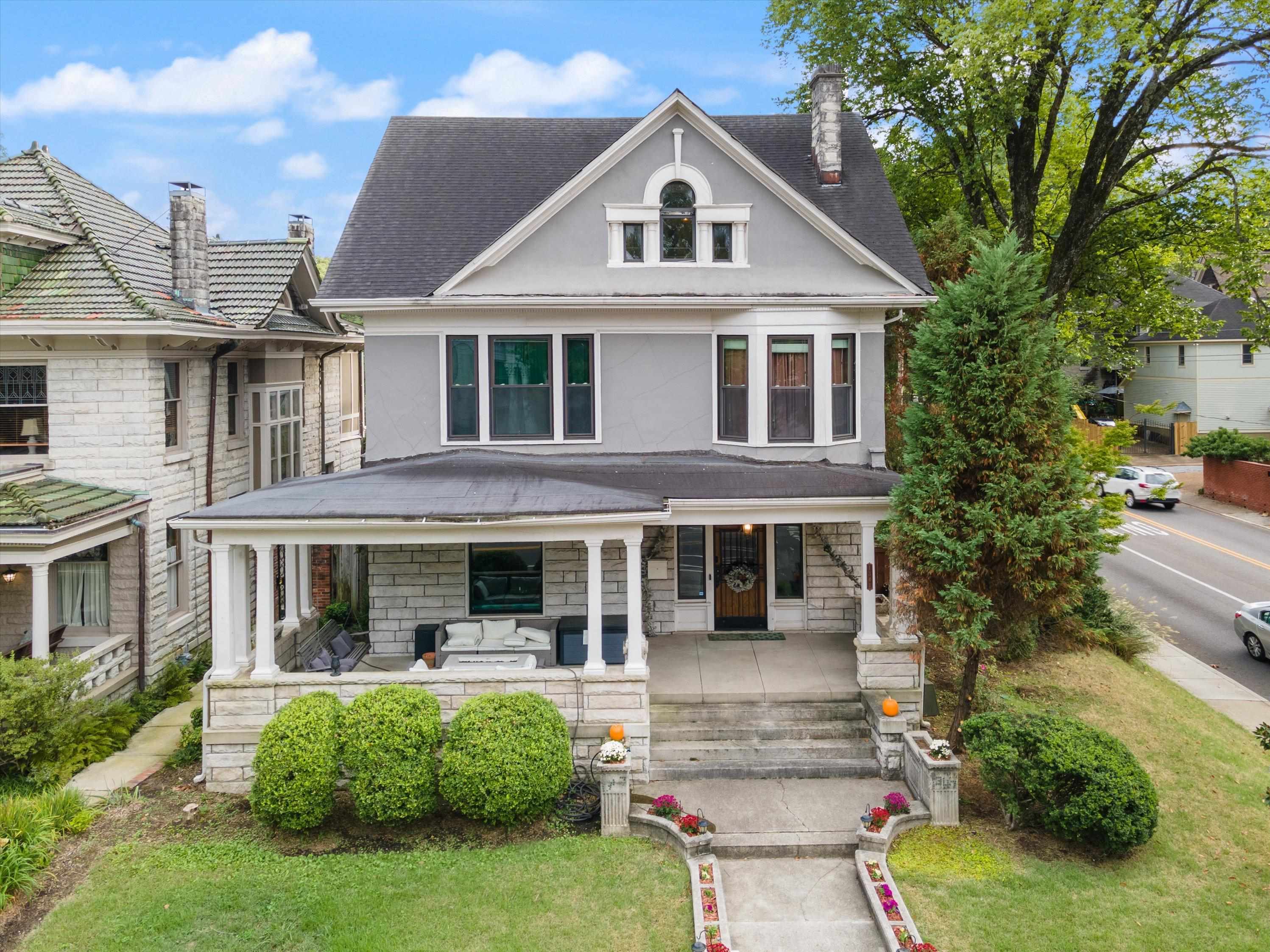 View of front of home featuring covered porch and a front yard