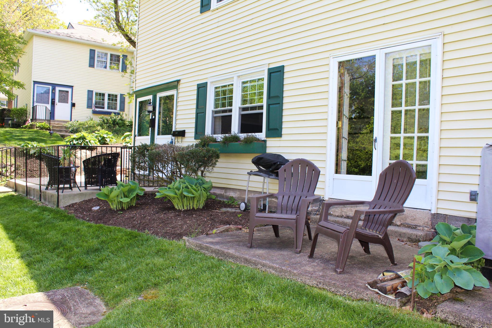 a view of a house with backyard sitting area and garden