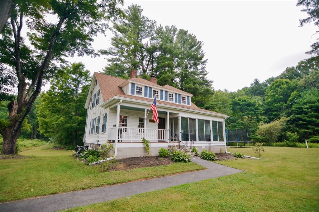 a front view of a house with a yard table and chairs