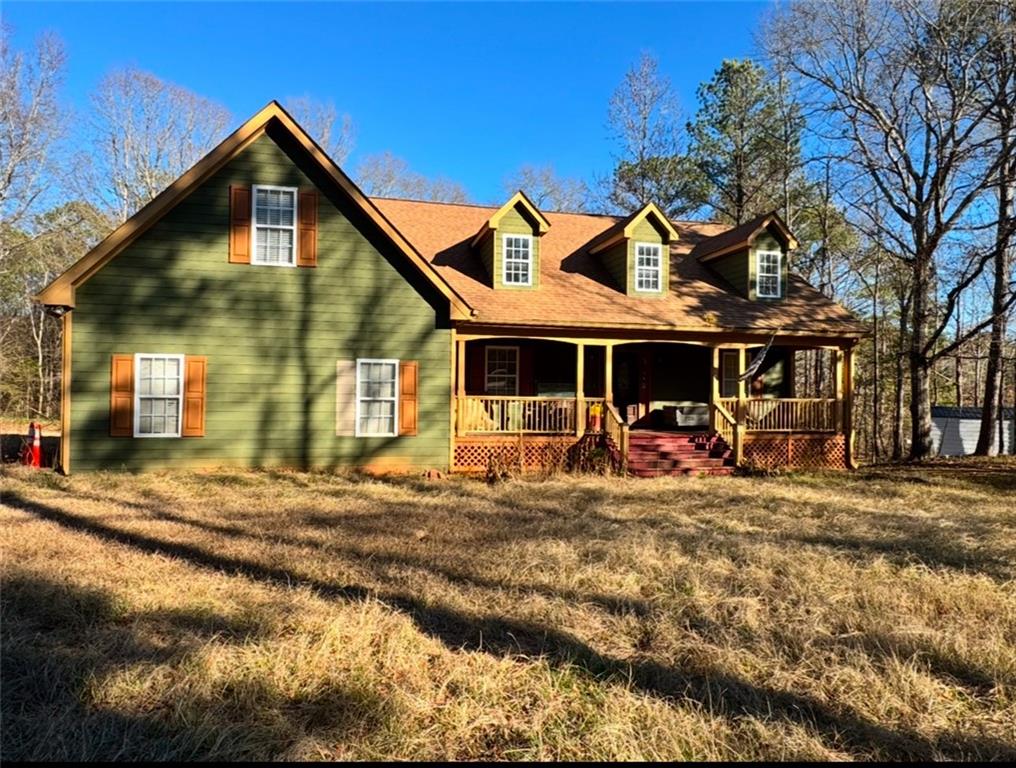 a view of a house with a small yard and sitting area