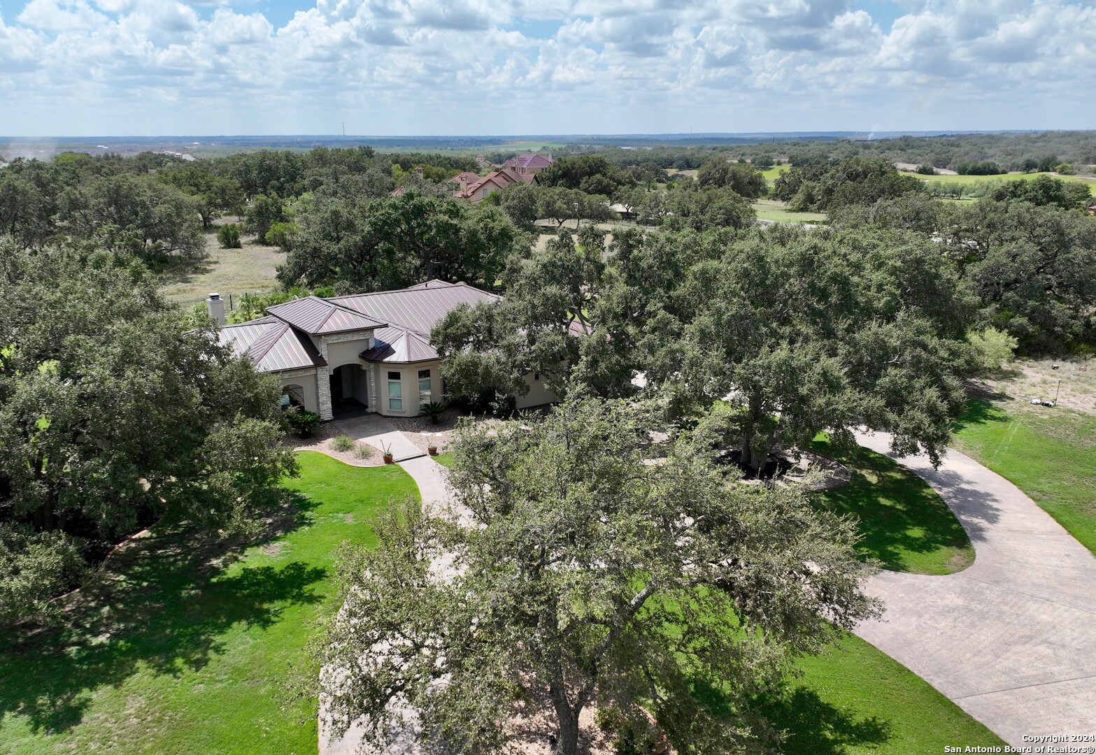 an aerial view of a house with a yard