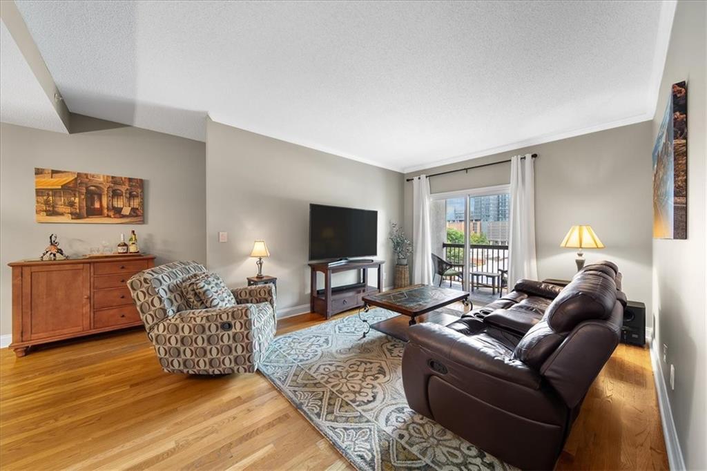 a living room with furniture window and a flat screen tv