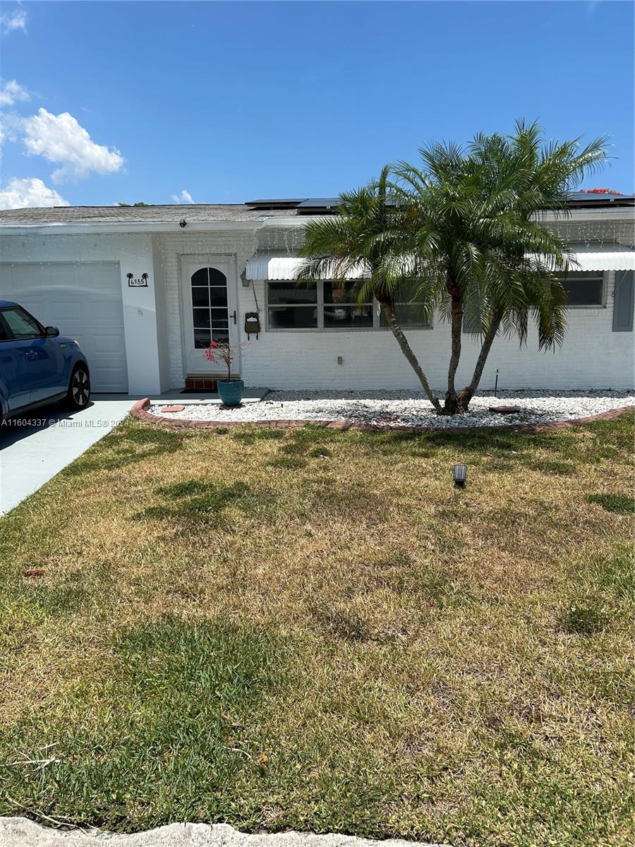 a view of a house with a yard