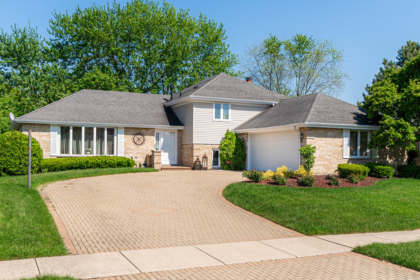 a front view of a house with a garden