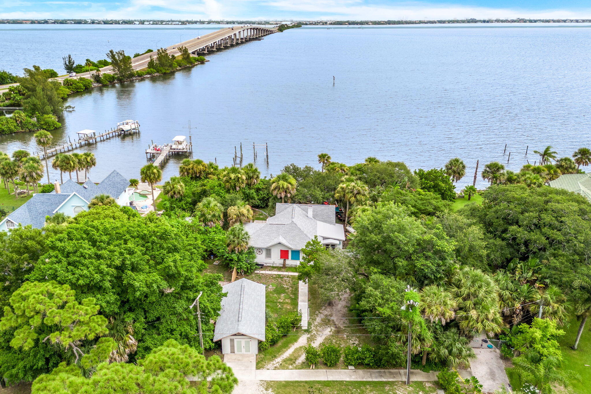 an aerial view of a house with a yard and lake view