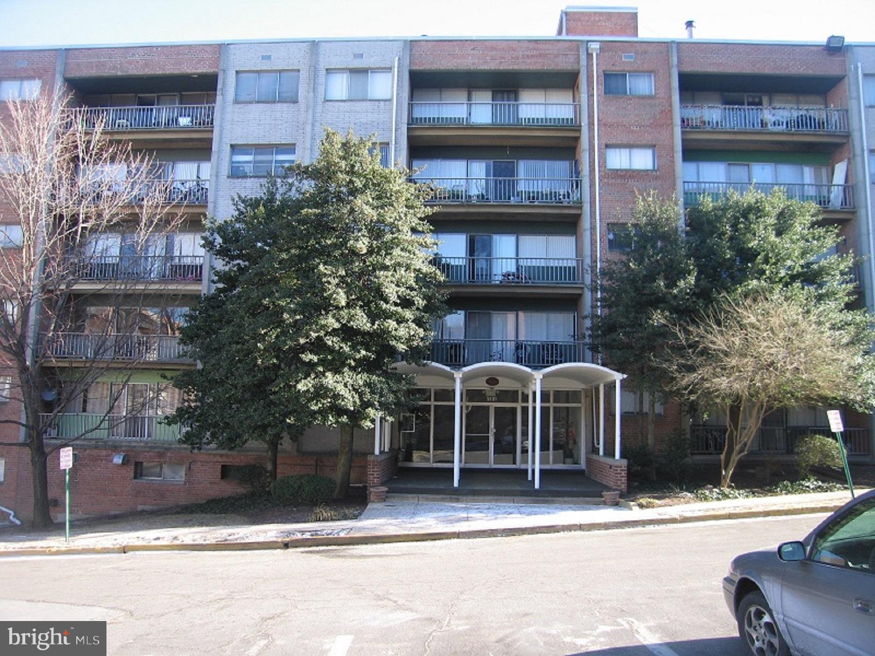 a view of a brick building next to a yard