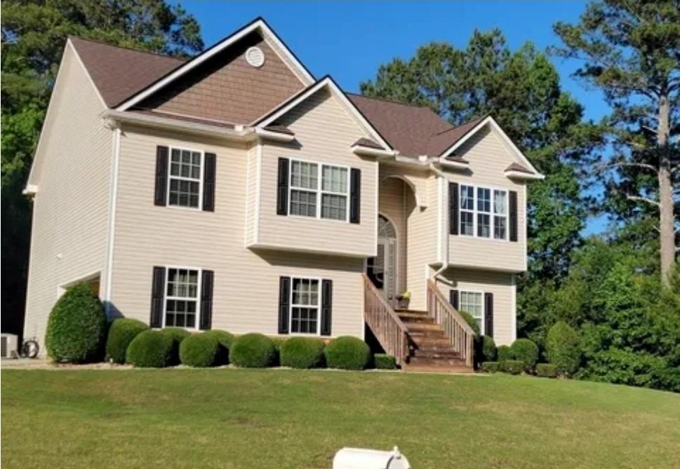 a front view of a house with a yard and garage