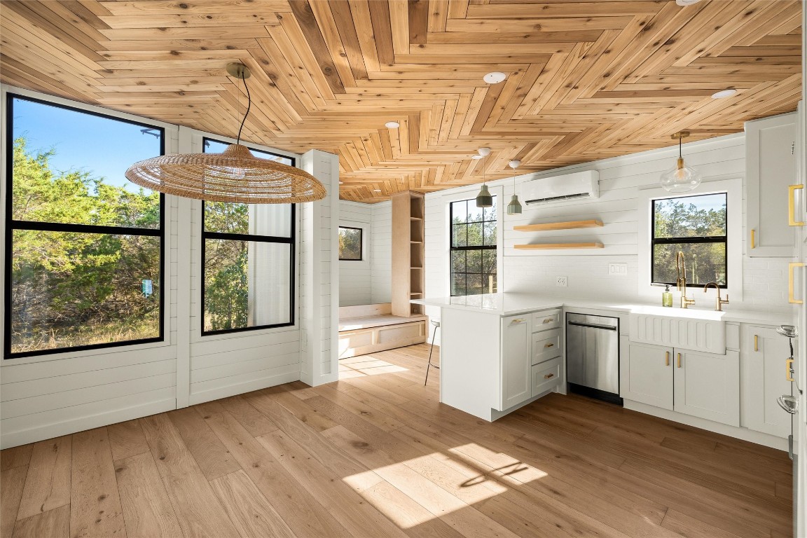 a kitchen with windows and refrigerator