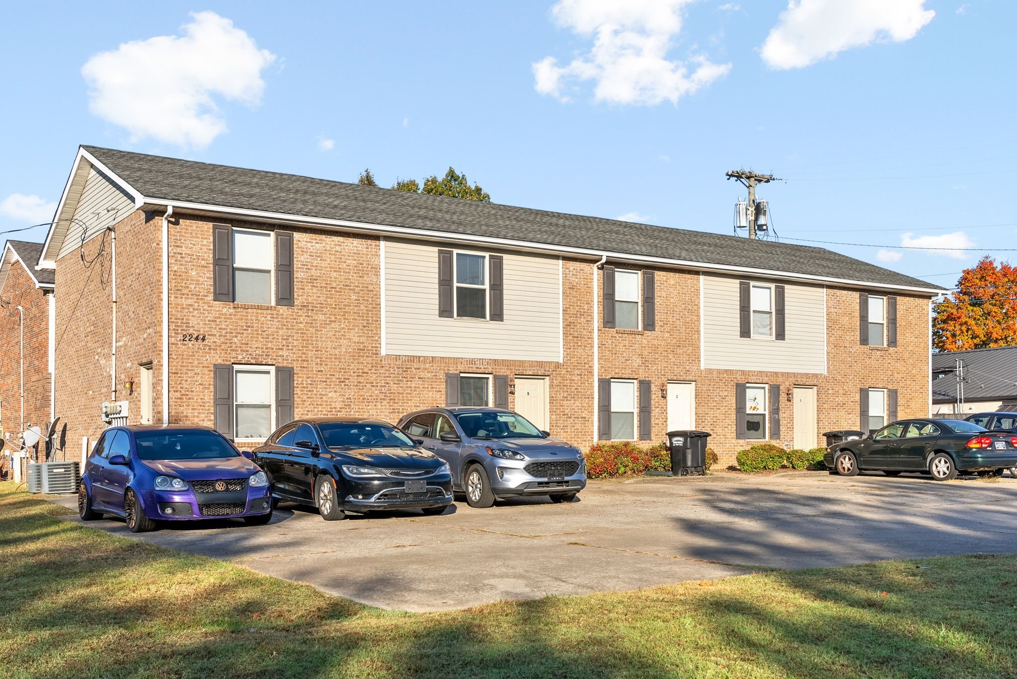 a view of a cars park in front of a building