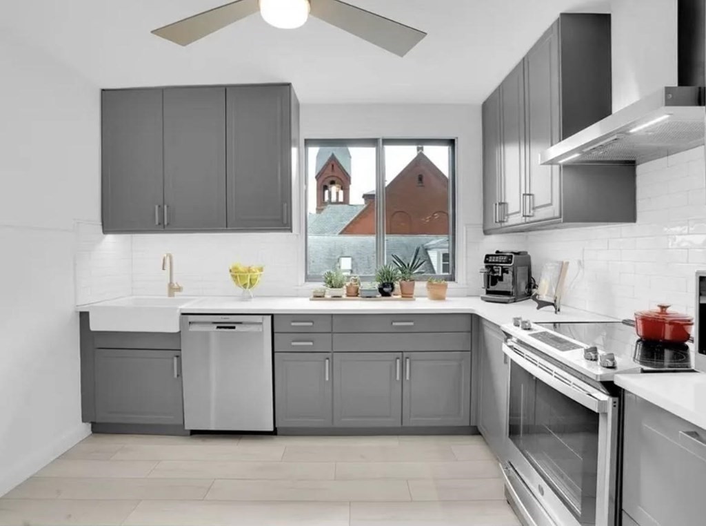 a kitchen with stainless steel appliances a sink stove and cabinets